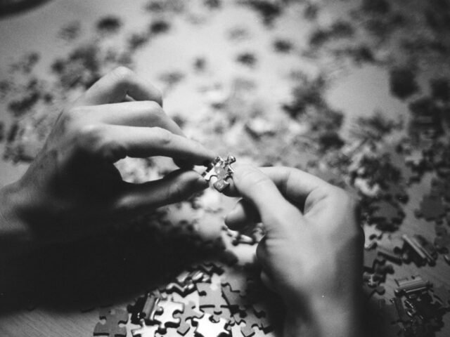 grayscale photo of person holding flower scaled